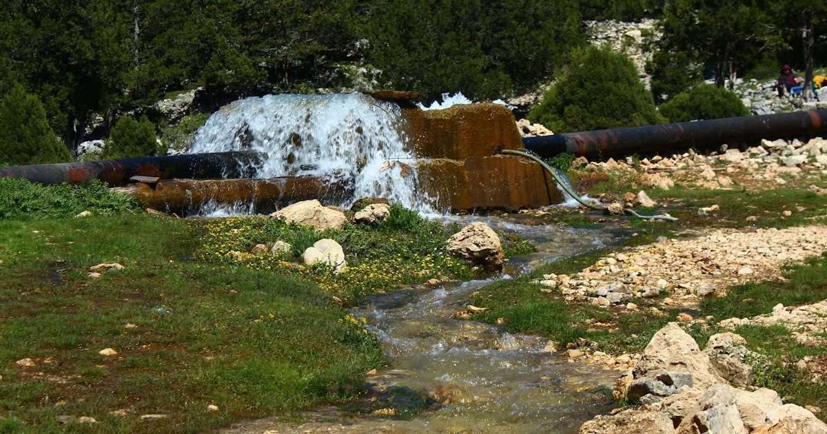 Spring water flowing out over rocks at a natural source